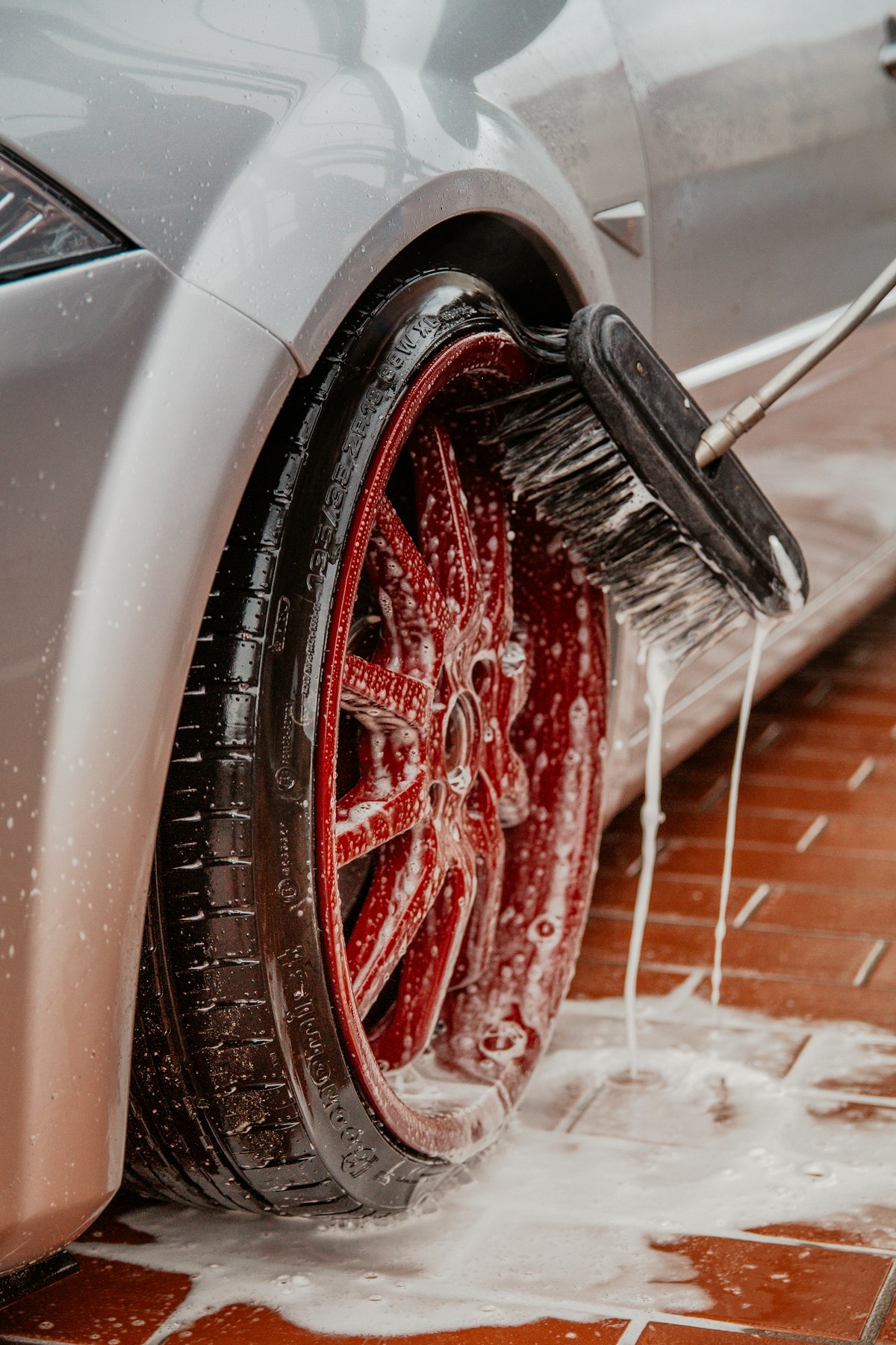 A wheel being scrubbed by hand